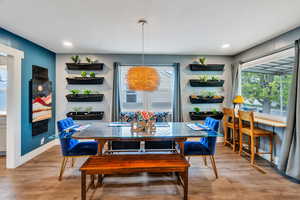 Dining area with wood finished floors and recessed lighting