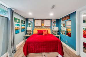 Bedroom with light wood finished floors and recessed lighting