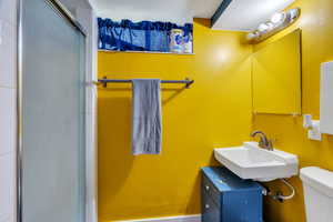 Bathroom with toilet and a stall shower