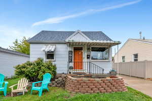 Bungalow-style house featuring roof with shingles