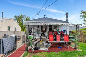 Back of property with roof with shingles, a patio area, and outdoor lounge area
