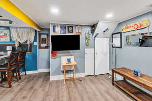 Recreation room featuring wood finished floors and recessed lighting