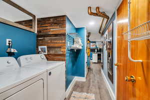 Laundry area featuring light wood-style flooring, recessed lighting, and independent washer and dryer