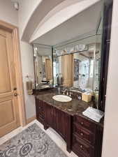 Full bath featuring a stall shower, vanity, and light tile patterned flooring