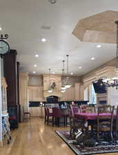 Dining area with light wood-style floors and recessed lighting