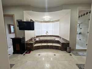 Full bathroom with a stall shower and a garden tub