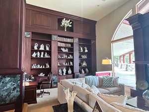 Carpeted office featuring built in desk and built in features