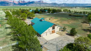 Aerial view of sparsely populated area with a mountain backdrop and agricultural land