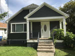 Bungalow-style home featuring a porch and a front yard