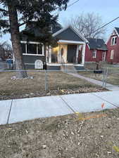 View of front of property featuring a fenced front yard, a porch, and a gate