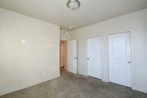 Unfurnished bedroom featuring carpet flooring and baseboards
