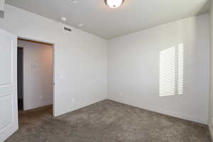 Unfurnished room featuring carpet flooring