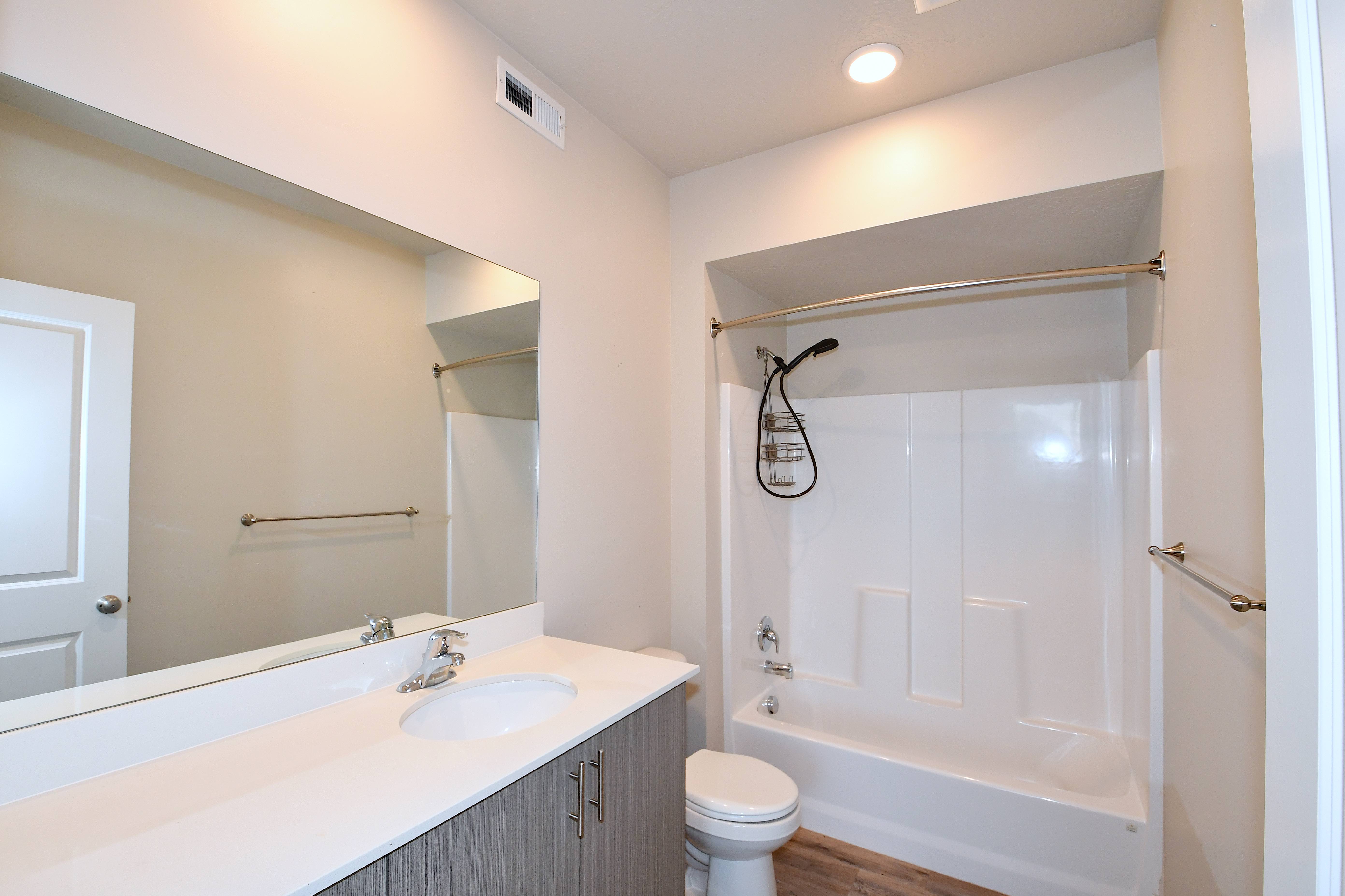 Full bath with vanity, bathtub / shower combination, recessed lighting, and dark wood finished floors