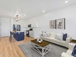 Virtually STAGED Living area with light wood-type flooring and recessed lighting