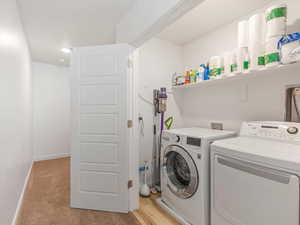 Laundry area with baseboards and washer and dryer