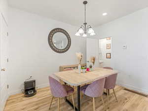 Dining room featuring a chandelier and light wood-style flooring