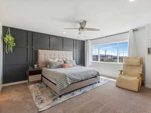 Bedroom with a decorative wall, carpet, recessed lighting, and ceiling fan