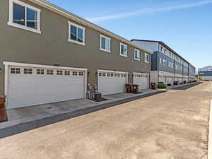 View of home's exterior with stucco siding and an attached garage