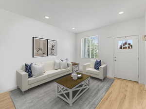 Virtually STAGED Living area with light wood-style floors and recessed lighting