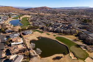 Aerial view of property's location featuring nearby suburban area and a water and mountain view