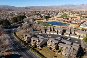 Aerial view of residential area featuring a water and mountain view and a golf course