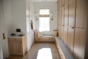 Next to entrance from garage