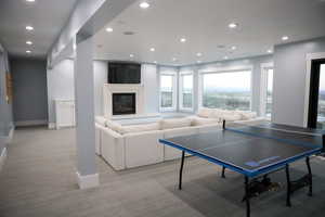 basement with a fireplace and floor to ceiling windows