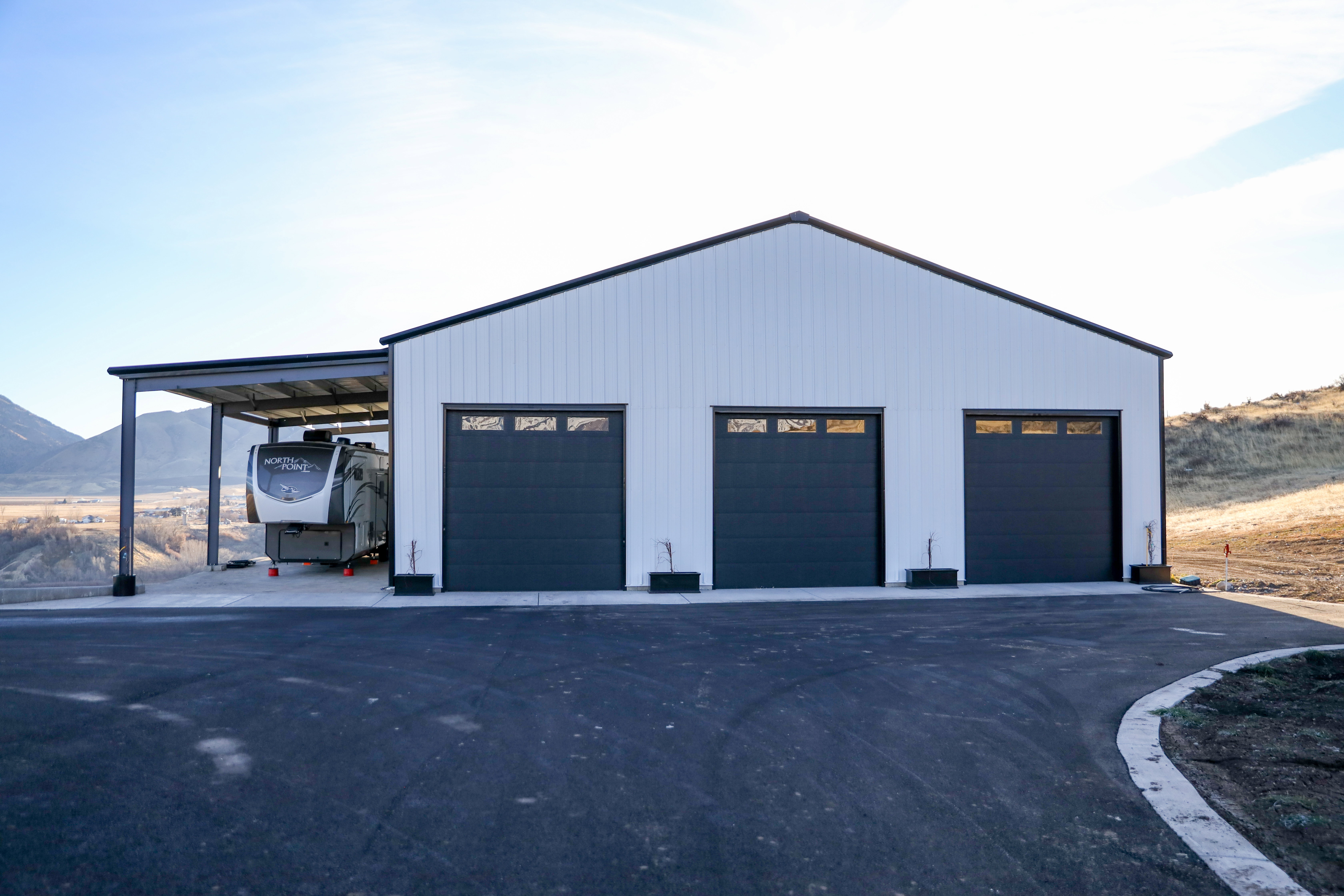 64x64 shop with covered RV parking and hookups