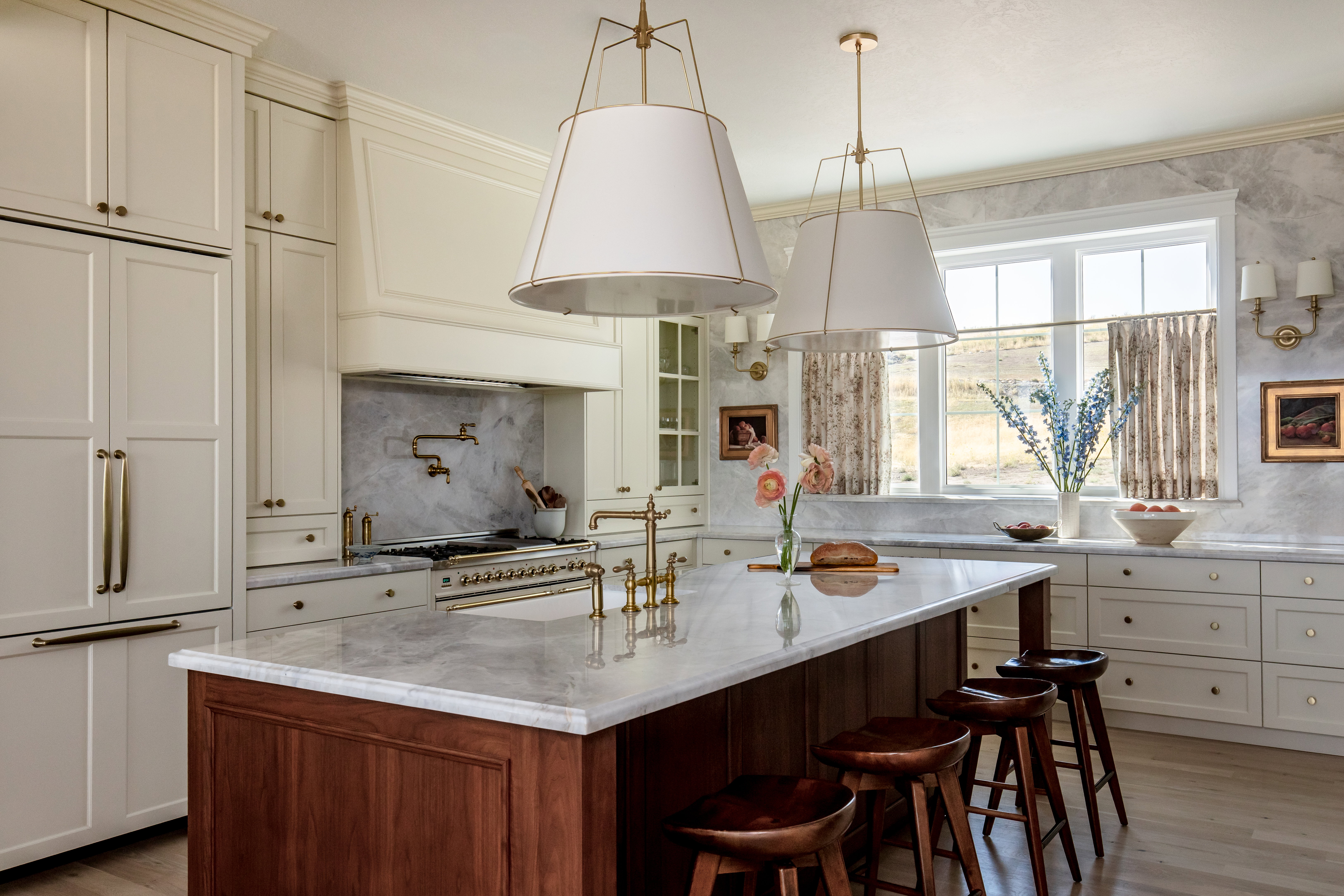 High end appliances, hardwood floors,  bar area, and a center island with sink
