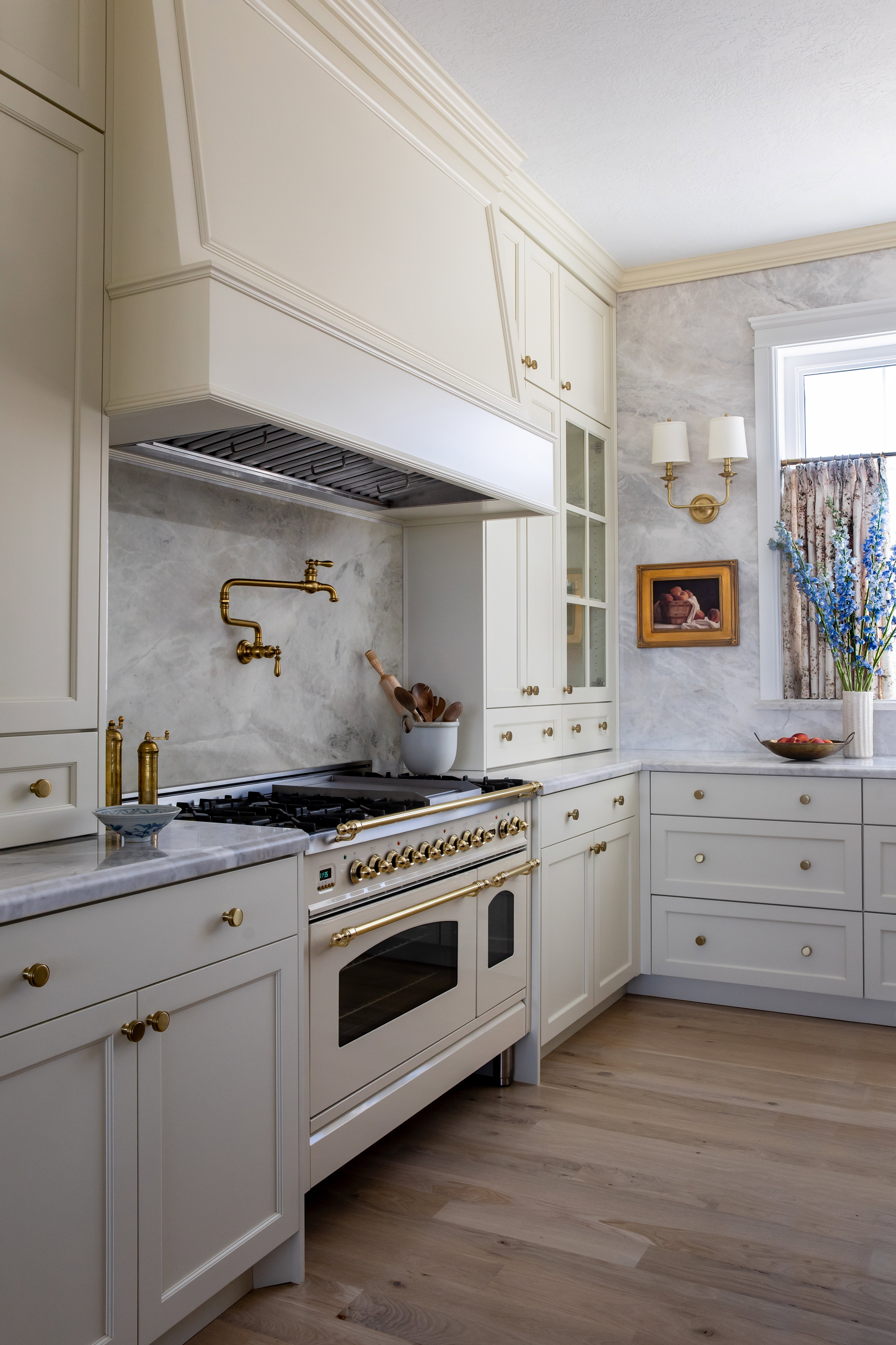 Kitchen featuring Italian gas range with two ovens, hardwood wood flooring, and marble countertops