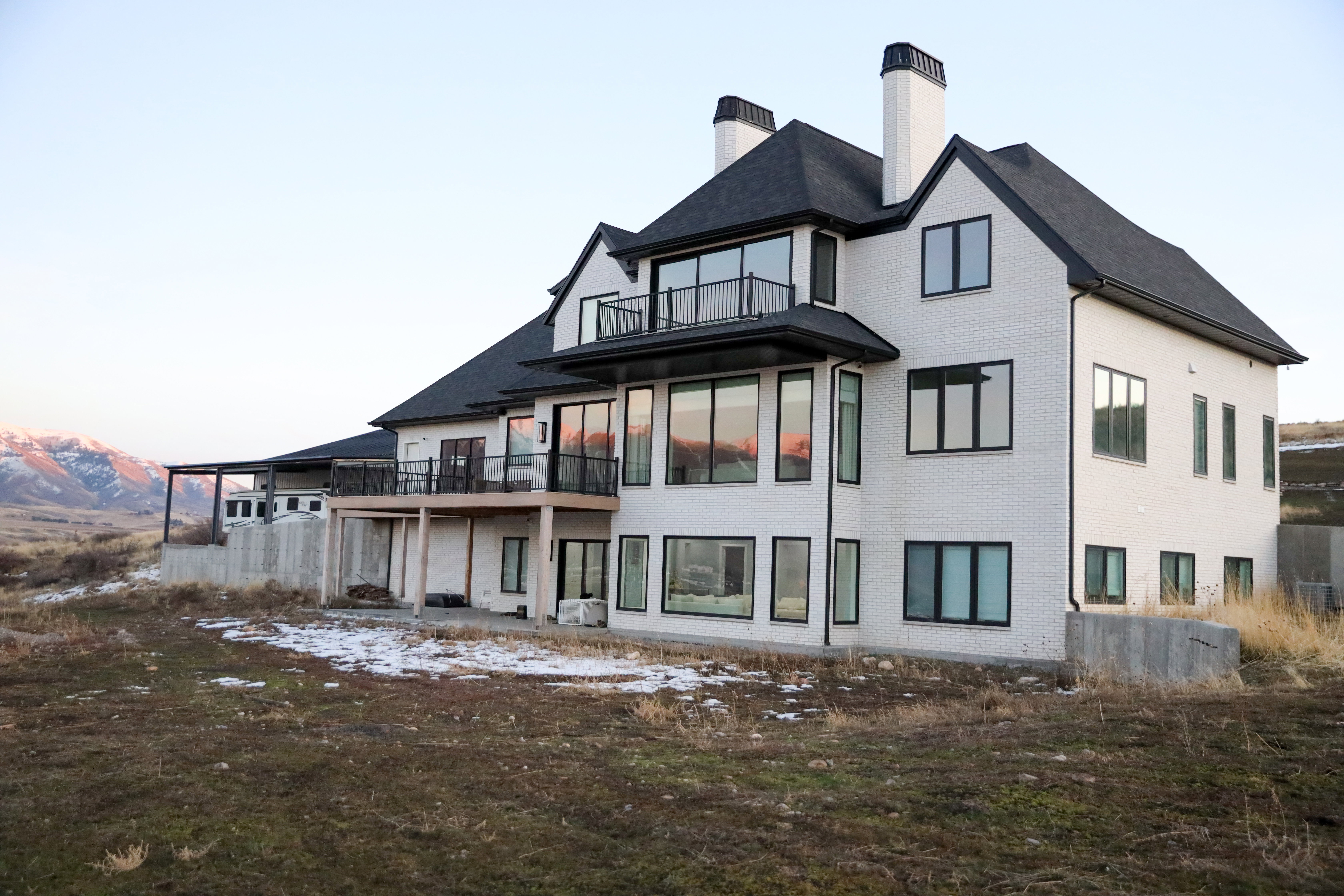 Back of house featuring brick, 2 decks, patio, walk out basement