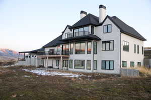 Back of house featuring brick, 2 decks, patio, walk out basement