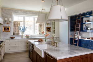 Marble throughout including around the window, pantry on the right with pocket doors