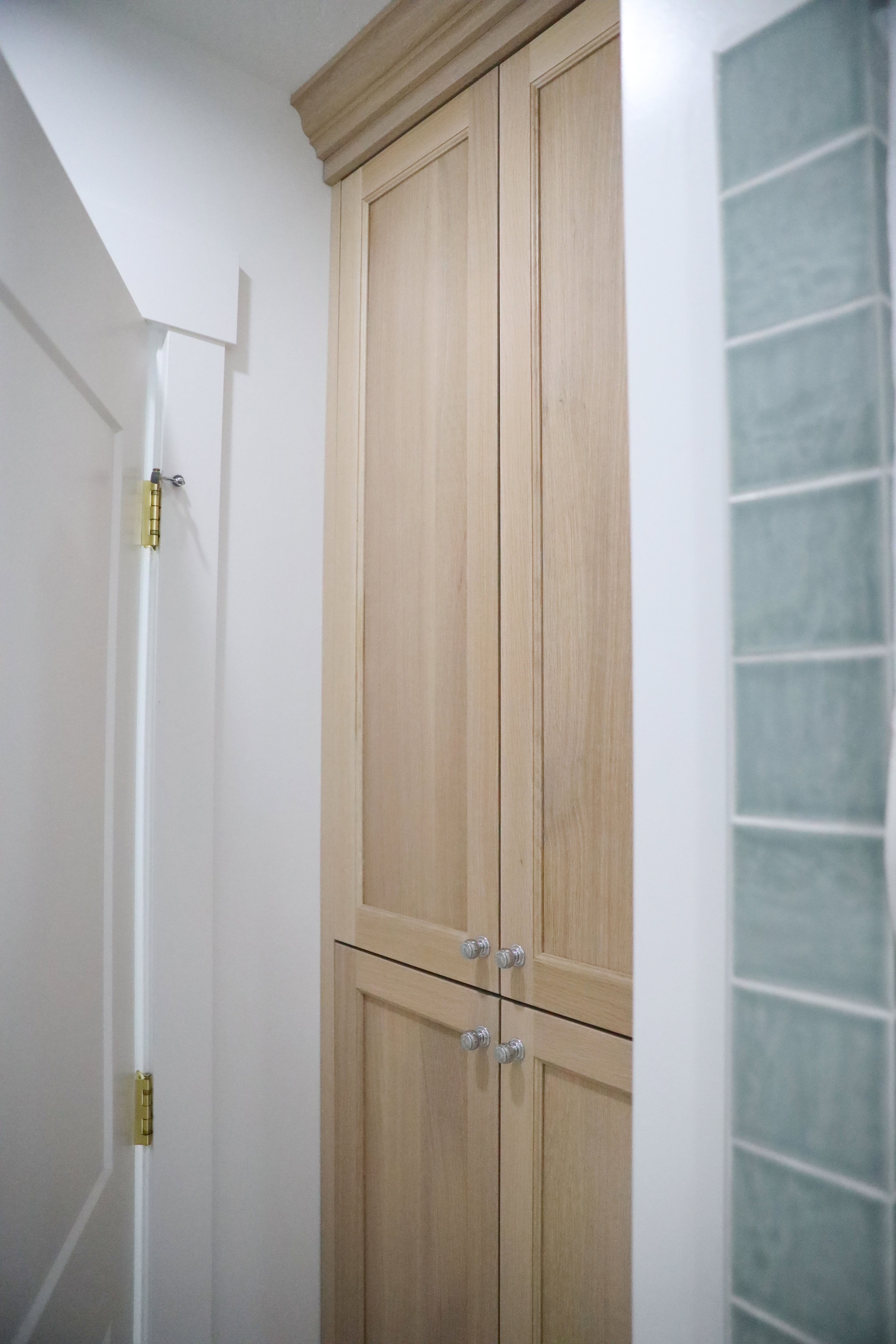 large white oak storage in basement bathroom