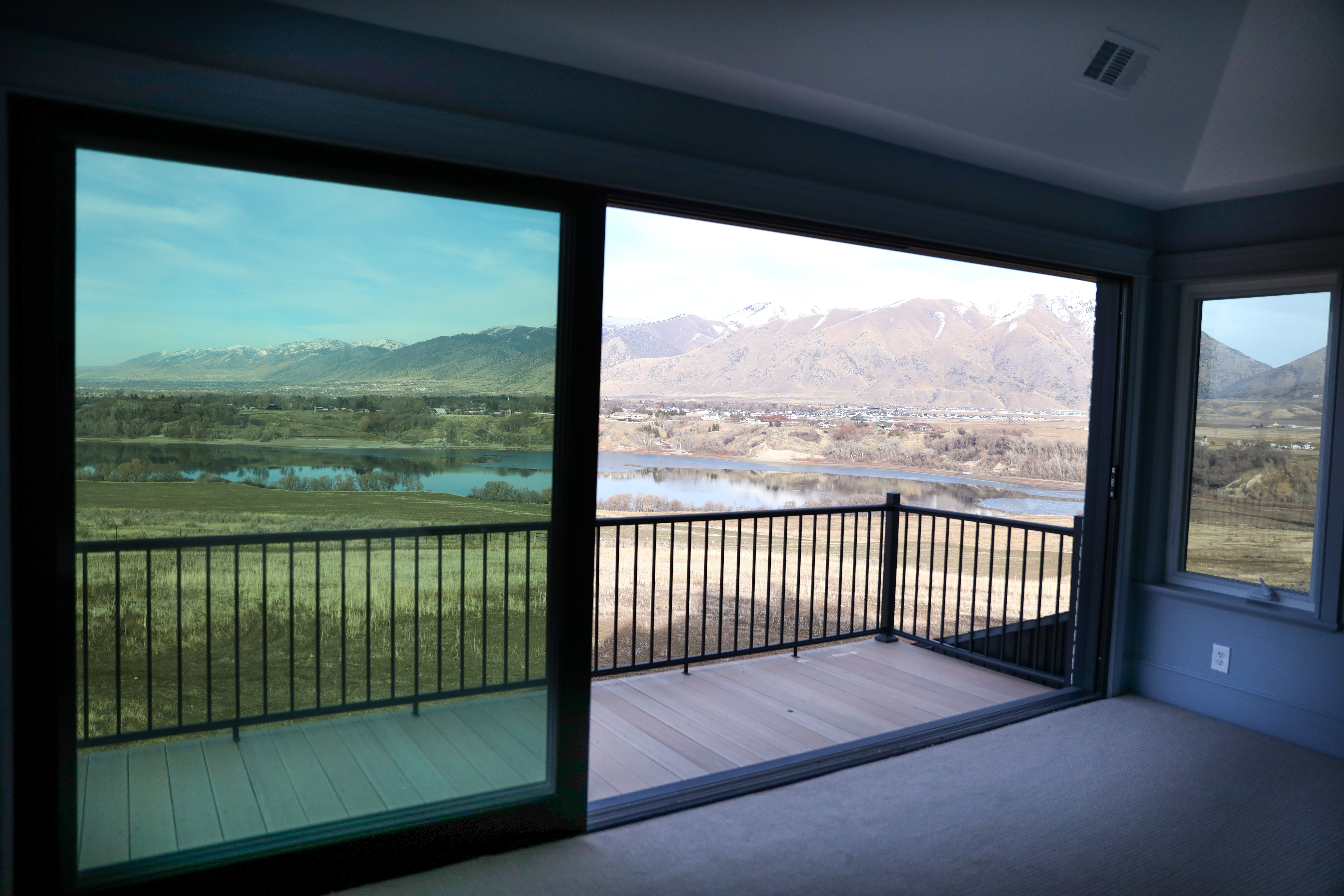 Balcony with lake and mountain view from a stacking sliding door