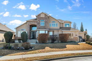 View of front facade with stone siding and stucco siding