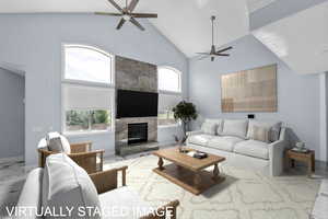 Living area featuring marble finish flooring, vaulted ceiling, a ceiling fan, and a fireplace