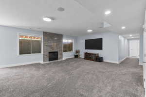 Unfurnished living room featuring carpet and a premium fireplace