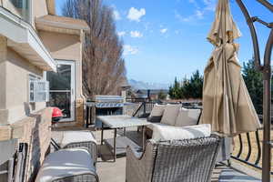 View of patio / terrace featuring an outdoor living space, a mountain view, and area for grilling
