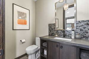 Bathroom featuring vanity and backsplash