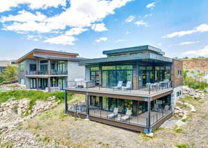 Back of property with a balcony