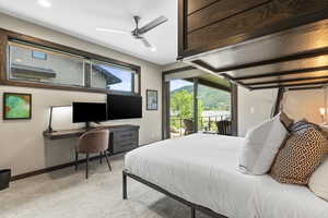 Bedroom with light carpet, access to outside, a ceiling fan, and built in study area