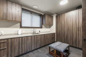 Kitchen with wood tiled floors and modern cabinets
