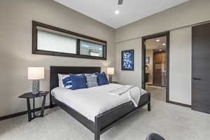 Bedroom featuring light colored carpet, recessed lighting, connected bathroom, and ceiling fan