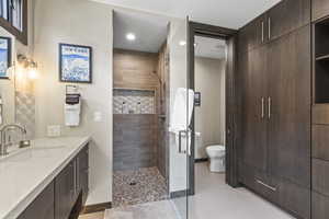 Full bathroom with vanity, a stall shower, and recessed lighting