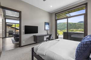 Carpeted bedroom featuring access to exterior, a ceiling fan, and recessed lighting