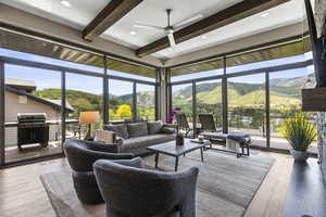 Sunroom featuring beamed ceiling