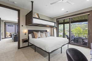 Bedroom featuring access to exterior, light colored carpet, recessed lighting, ceiling fan, and a mountain view