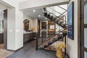 Foyer with dark wood-style floors and recessed lighting