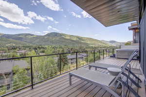 Deck featuring a mountain view and a hot tub